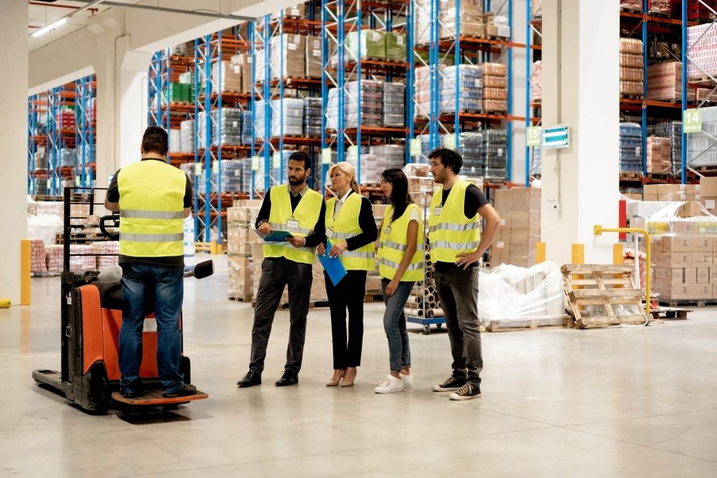 Warehouse staff learning to use forklift for proper storage management