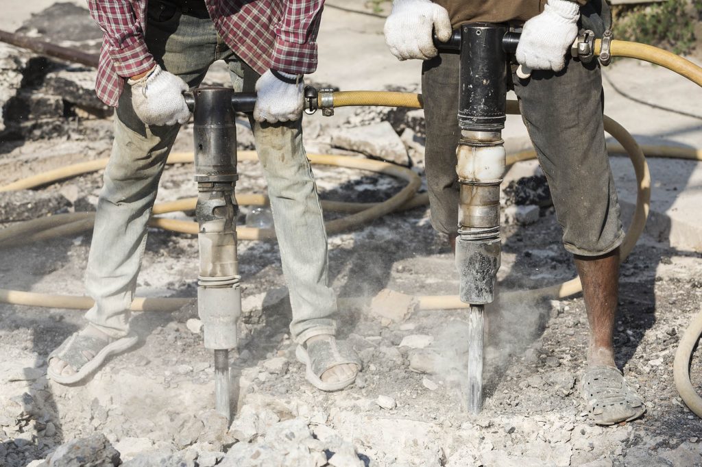 Construction workers using heavy duty drills causing hand-arm vibration syndrome and vibration white finger - industrial disease